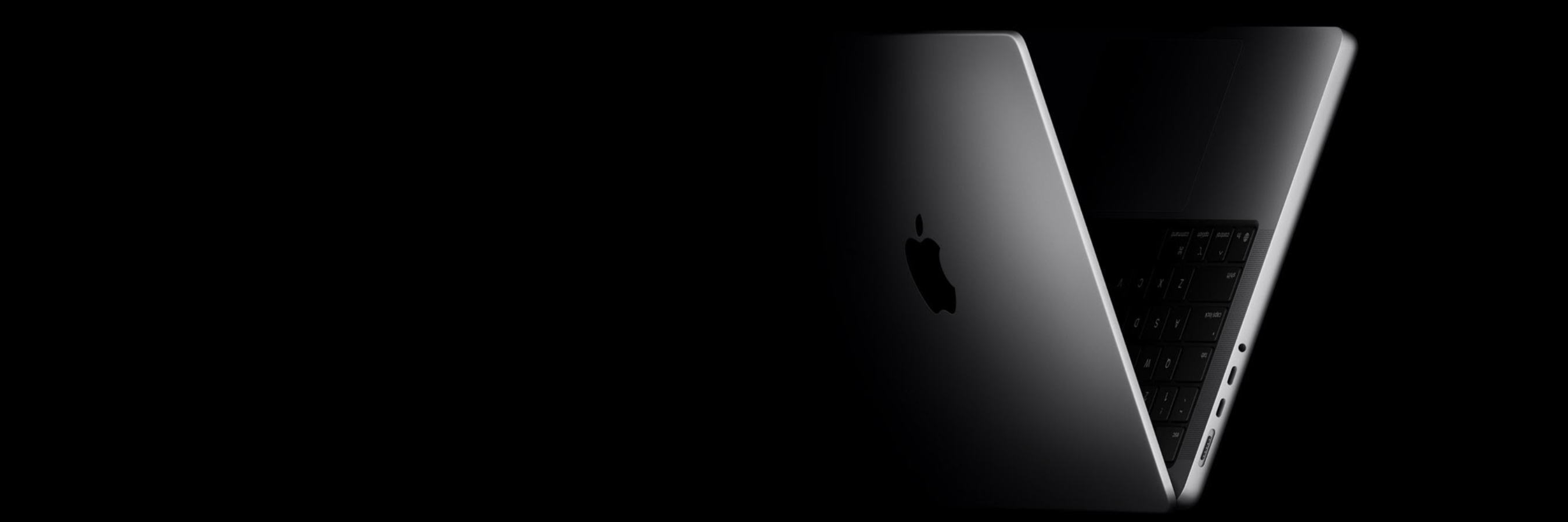 black background with silver MacBook Pro fading into the black