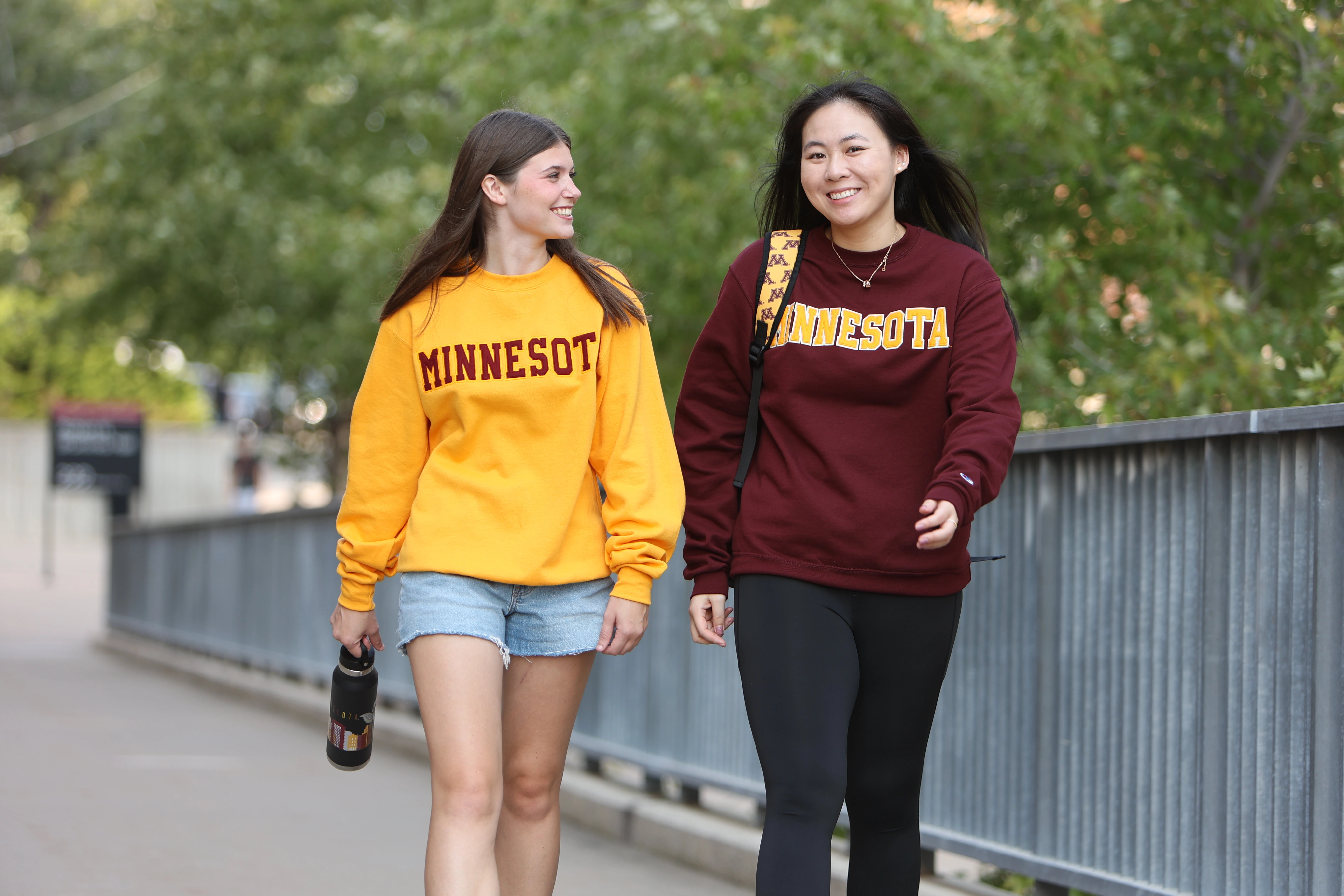 Two students walking on campus