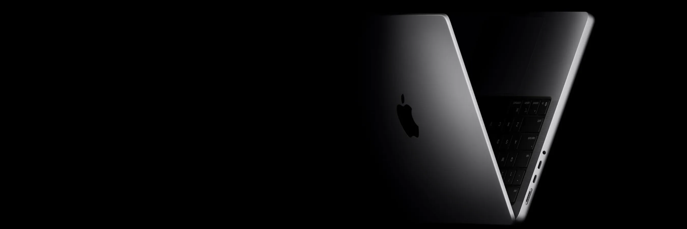 black background with silver MacBook Pro fading into the black