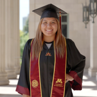 student wearing graduation cap, gown, and stole