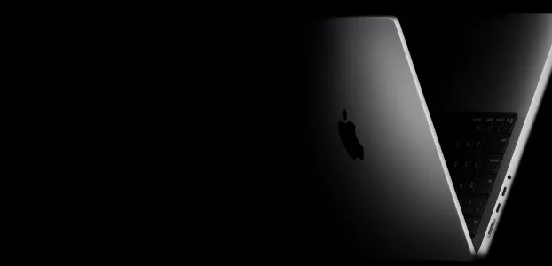 black background with silver MacBook Pro fading into the black
