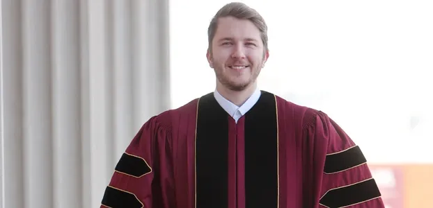 Male student in fine quality doctorate regalia
